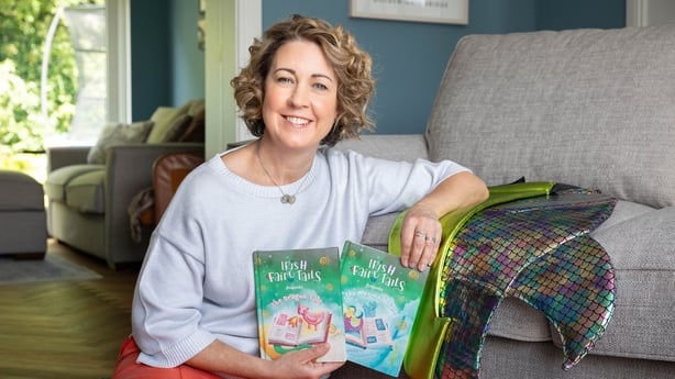 woman posing with two books