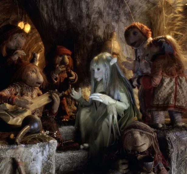 The Gelfling Kira is entertained by the Podlings, in a scene from the animatronic fantasy film 'The Dark Crystal', 1982