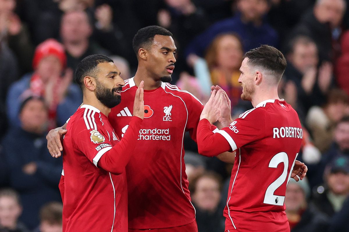Mohamed Salah of Liverpool celebrates scoring his team's first goal with teammates Ryan Gravenberch and Andrew Robertson during the Premier League match between Liverpool and Aston Villa at Anfield on November 01, 2025 in Liverpool, England.