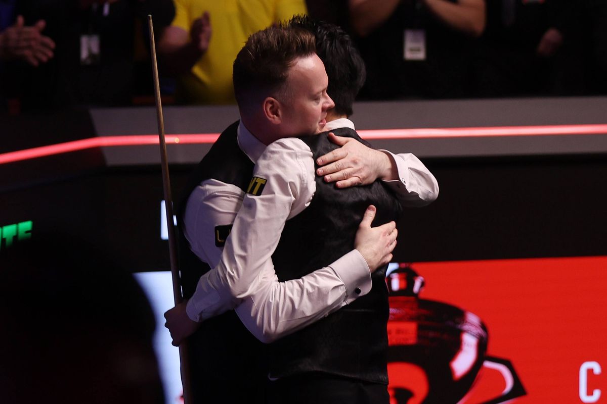 Shaun Murphy of England congratulates Wu Yize of People's Republic of China on his victory after their fourth session of the final match on day seventeen of the Halo World Snooker Championship at The Crucible Theatre on May 04, 2026 in Sheffield, England. 
