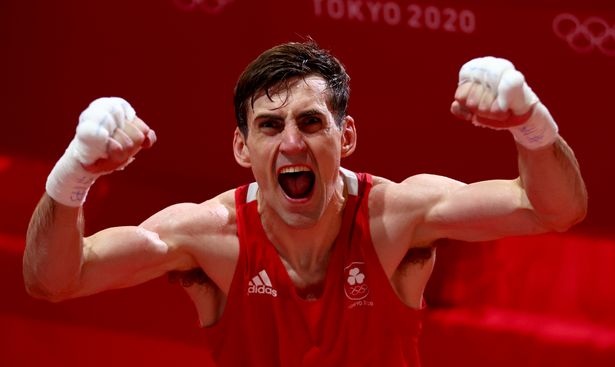 Ireland's Aidan Walsh celebrates beating Merven Clair (blue) of Mauritius in Tokyo