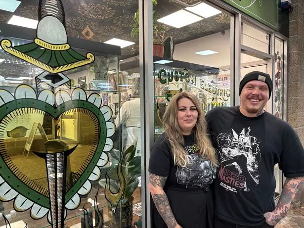 Bronwen Edwards and Elliott 'Elmo' Moret outside Sacred Heart Tattoo and Piercing