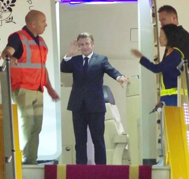 The French president looks surprised after his wife appears to slap him