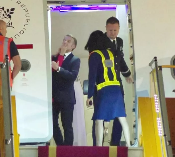 Moment Emmanuel Macron's wife appears to slap him as they 'bicker' during official tour