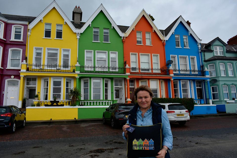 Jennie outside a row of homes in Whitehead that inspired one of her designs