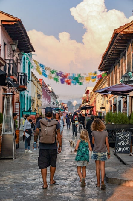 A man, woman and child in a street in Mexico