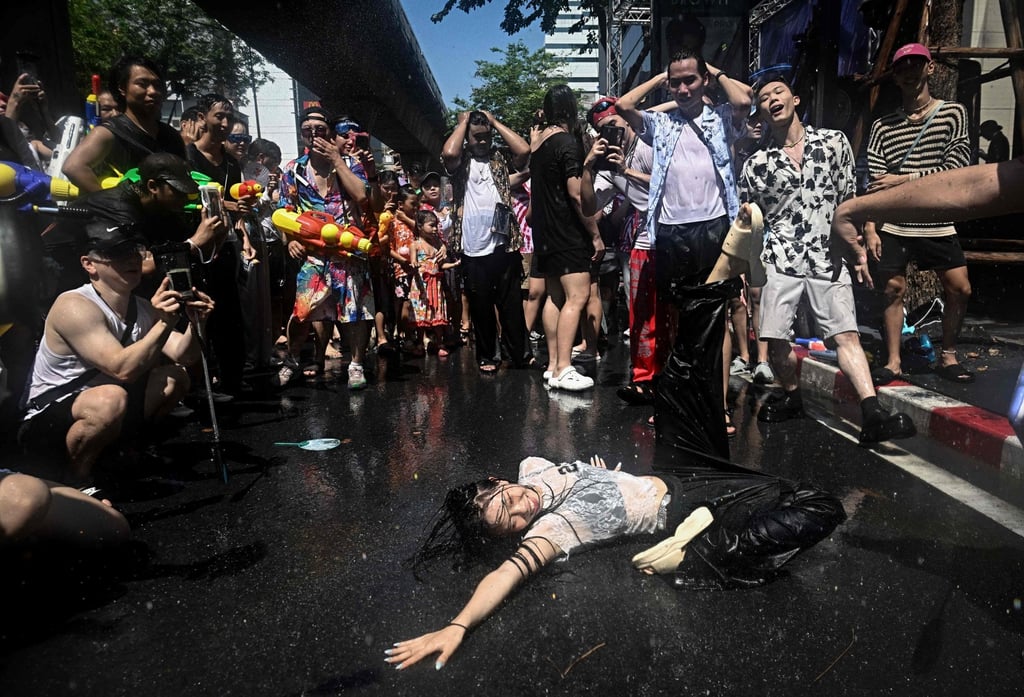 Revellers in Silom Road, Bangkok, dance on the street on Sunday, the eve of the Songkran. Photo: AFP Revellers in Silom Road, Bangkok, dance on the street on Sunday, the eve of the Songkran. Photo: AFP