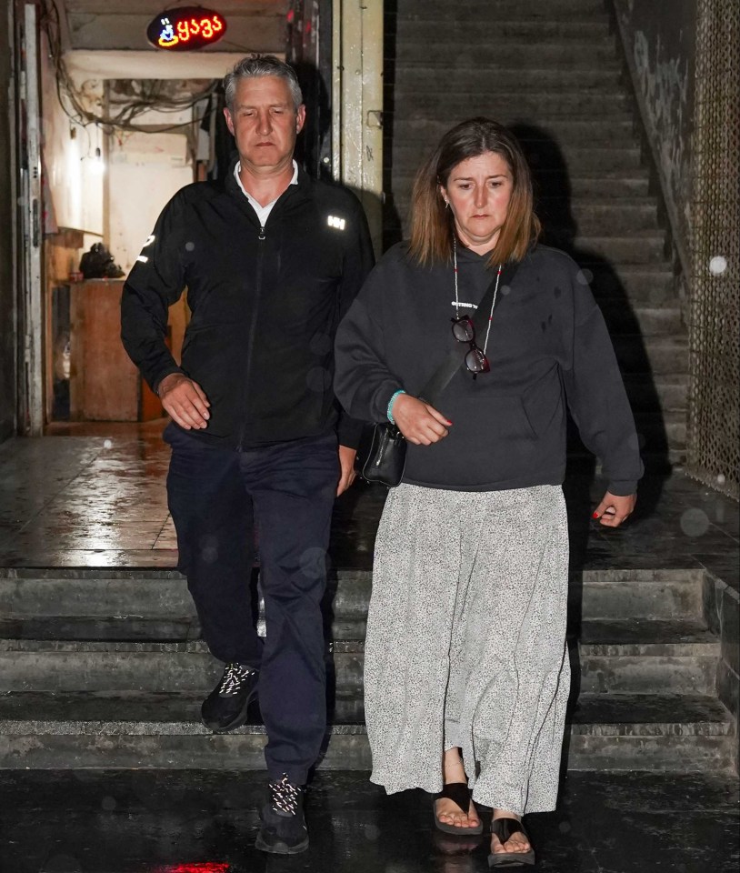 A man and woman leaving a lawyers office.