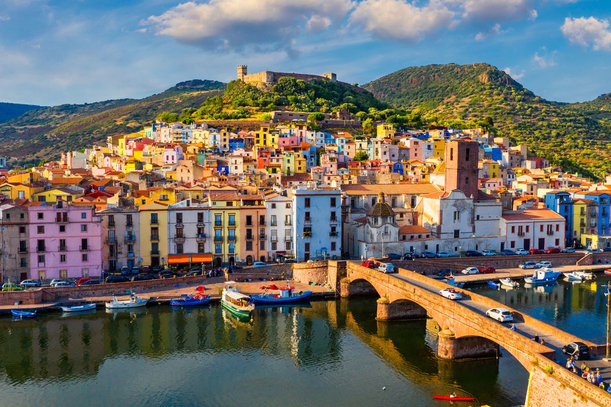 Aerial view of the beautiful village of Bosa with colored houses and a medieval castle.