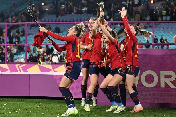 Spain players celebrate with the trophy