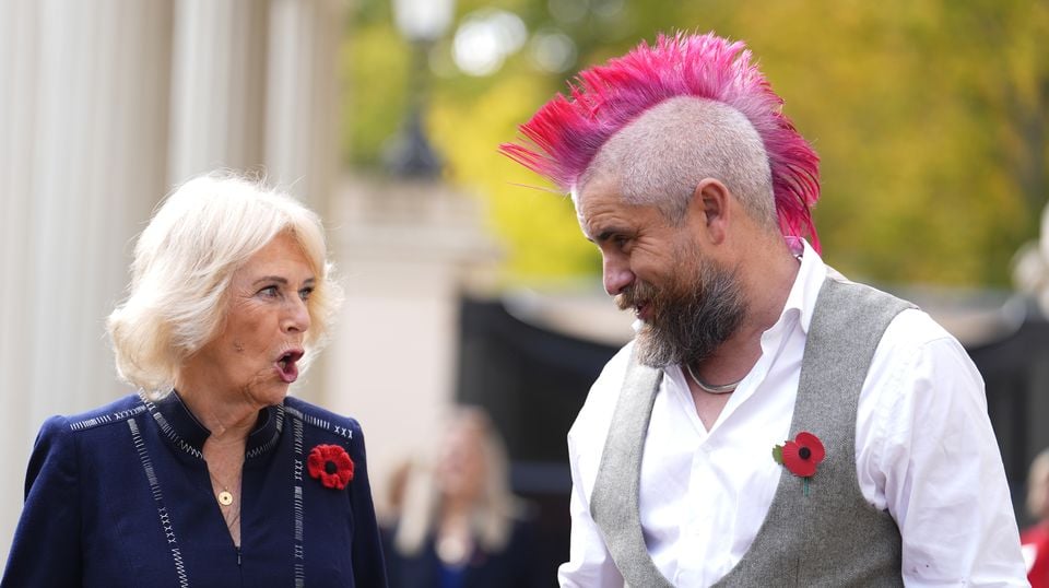 Camilla is escorted to ‘The Role of a Lunchtime’ street food truck by TikTok star Spudman (Jordan Pettitt/PA)