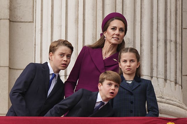 Prince George, Prince Louis, the Princess of Wales, and Princess Charlotte on the balcony of Buckingham Palace for the VE Day anniversary fly past