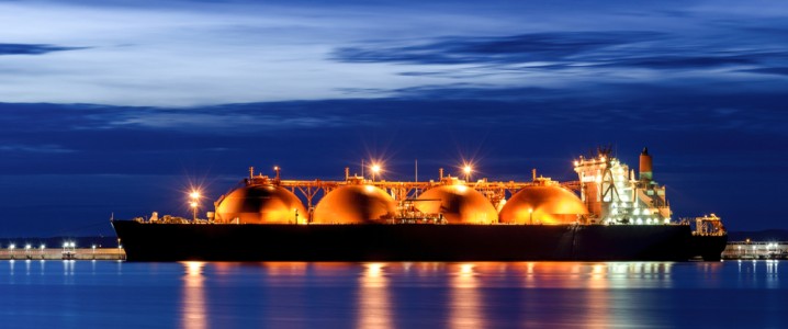 LNG tanker lit up at night in the distance. LNG tanker lit up at night in the distance.