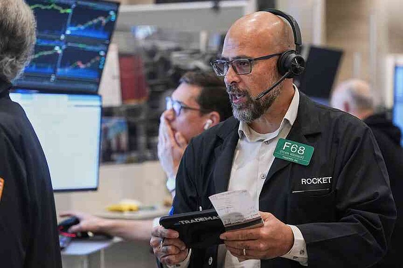 Options trader Steven Rodriguez works on the floor of the New York Stock Exchange, Monday, Oct. 13, 2025. (AP Photo/Richard Drew)