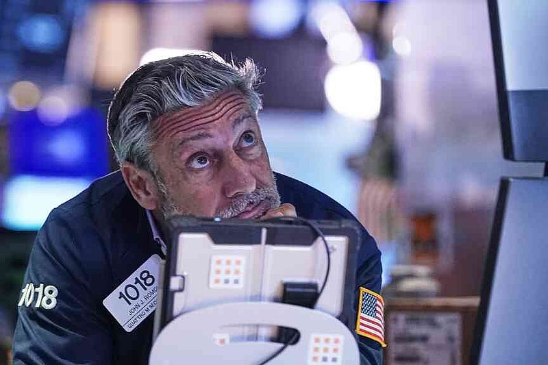 Trader John Romolo works on the floor of the New York Stock Exchange, Monday, Oct. 13, 2025. (AP Photo/Richard Drew)