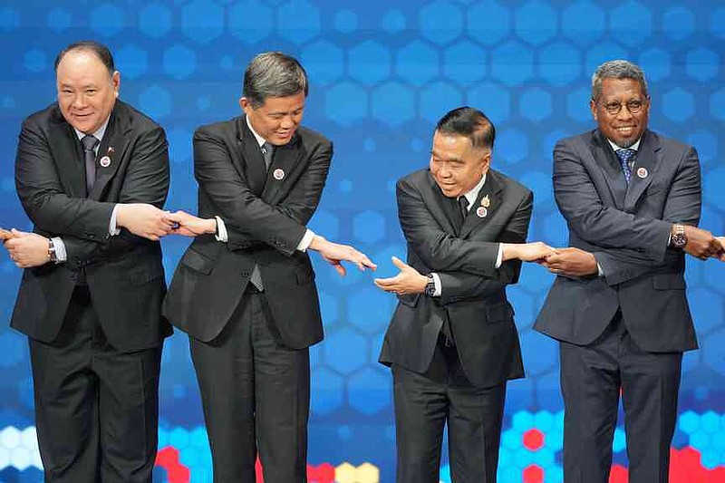 From left, Philippine's Defense Secretary Gilberto Teodoro, Singapore's Defense Minister Chan Chun Sing, Thailand's Defense Minister Natthaphon Narkphanit and East Timor's Defense Minister Donaciano da Costa Gomes hold hands as they pose for a group photo during the opening session of the Association of Southeast Asian Nations (ASEAN) Defense Ministers' Meeting in Kuala Lumpur, Malaysia, Friday, Oct. 31, 2025. (AP Photo/Dita Alangkara, Pool)