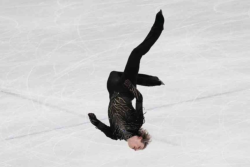 Ilia Malinin of the United States does a back flip while competing during the men's free skate program in figure skating at the 2026 Winter Olympics, in Milan, Italy, Friday, Feb. 13, 2026. (AP Photo/Stephanie Scarbrough)