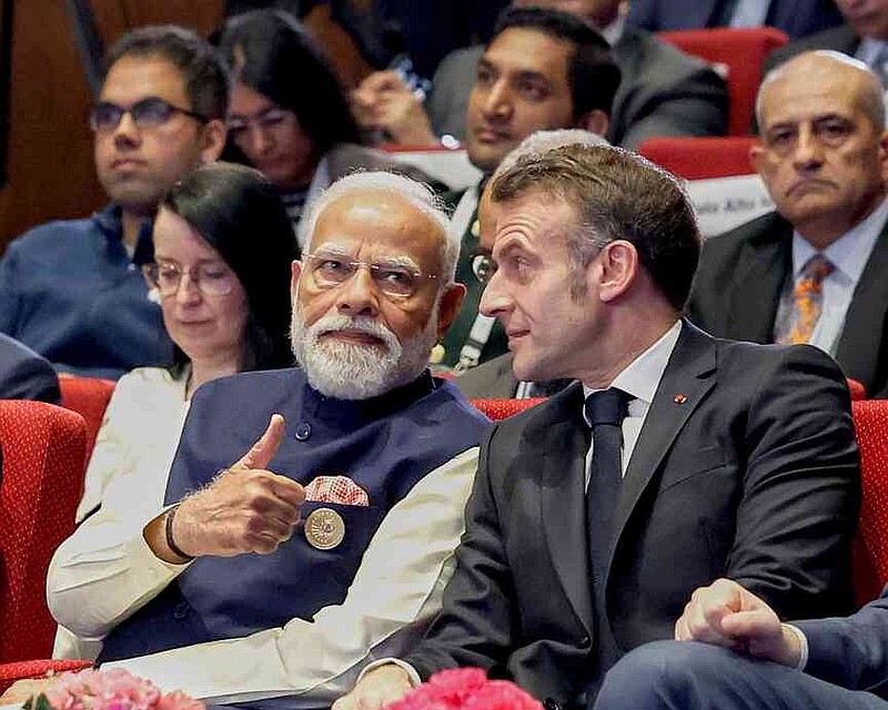 India's Prime Minister Narendra Modi, left, talks with French President Emmanuel Macron during the AI Summit in New Delhi, India, Thursday, Feb.19, 2026. (Indian Prime Minister's Office via AP)
