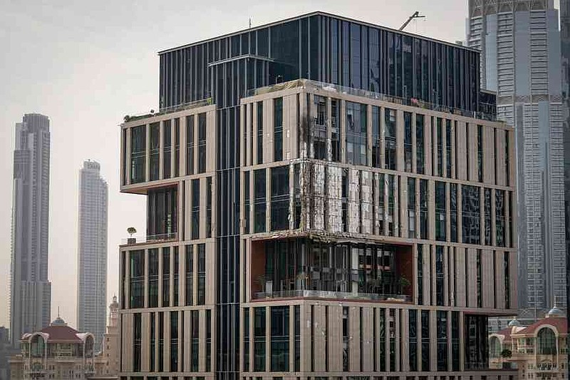 Facade of a building at Dubai's financial district is seen partially damaged which, according to the authorities was caused by falling debris after a successful interception, United Arab Emirates, Friday, March 13, 2026. (AP Photo/Altaf Qadri)