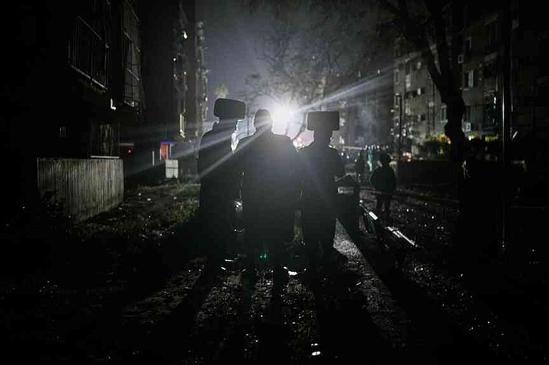 Ultra-Orthodox Jewish men watch as Israeli security forces and rescue teams operate at the site hit by an Iranian missile in Arad, southern Israel, Sunday, March 22, 2026. (AP Photo/Ohad Zwigenberg)
