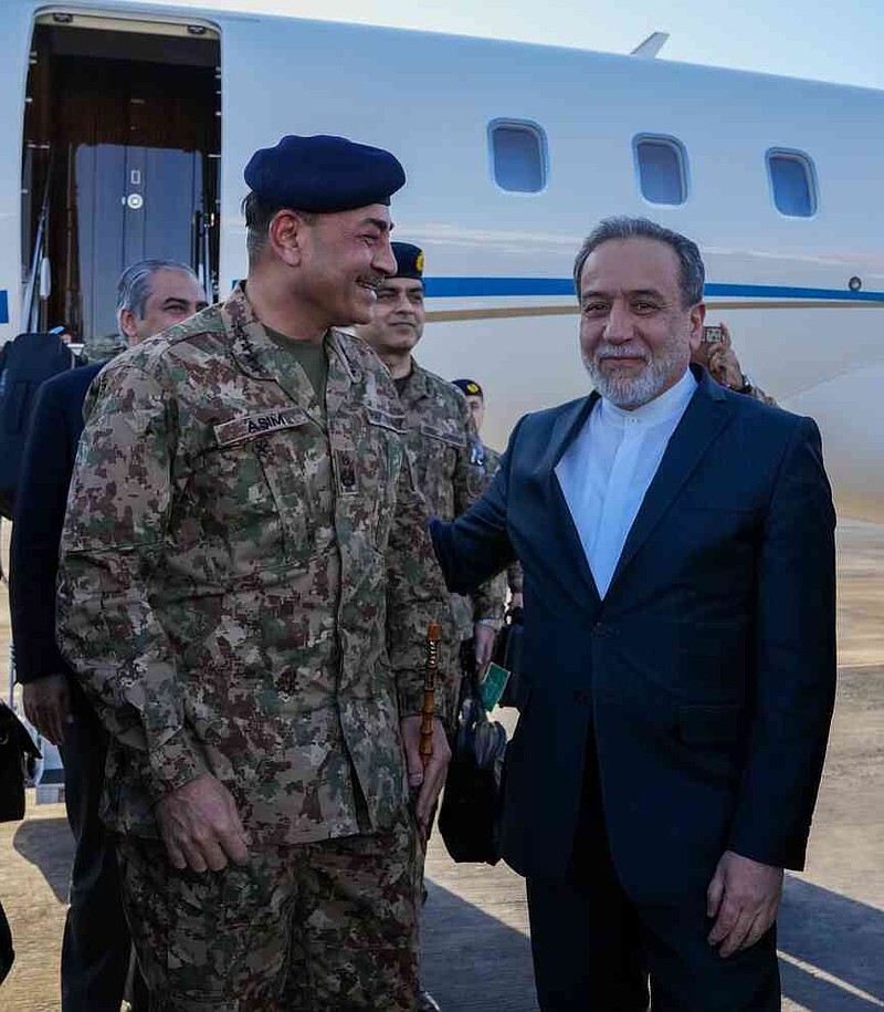 In this photo released by the Iranian Foreign Ministry, Pakistan's Army Chief Field Marshal Gen. Asim Munir, left, is welcomed by Iranian Foreign Minister Abbas Araghchi upon his arrival in Tehran, Wednesday, April 15, 2026. (Iranian Foreign Ministry via AP)