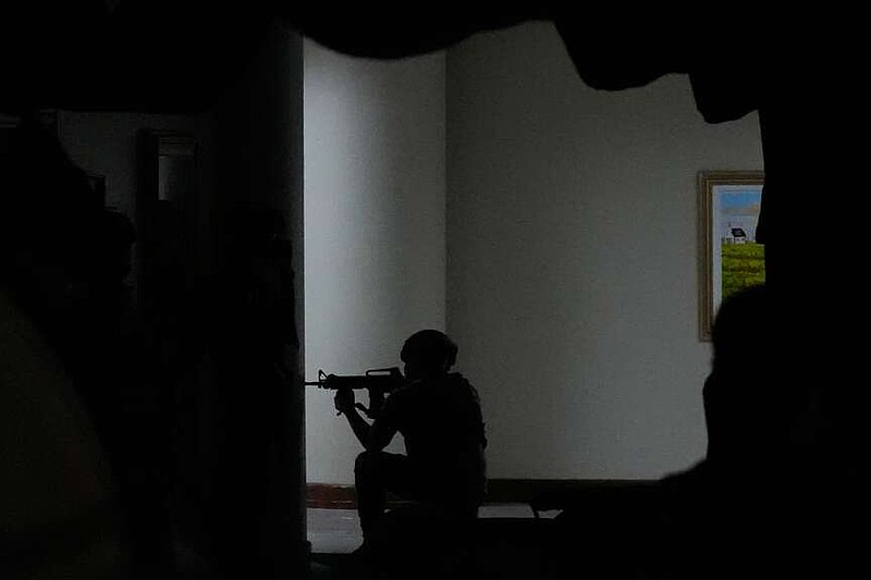 Philippine troopers secure an area after gunfire was heard at the Philippine Senate in Pasay, Philippines on Wednesday, May 13, 2026. (AP Photo/Aaron Favila)