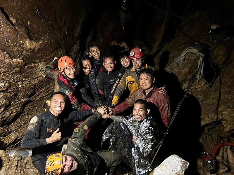 This image released by Metta Tham Rescue Kalasin, shows rescue workers gathering in a flooded cave in Xaisomboun province, Laos, Friday, May 29, 2026. (Metta Tham Rescue Kalasin via AP)