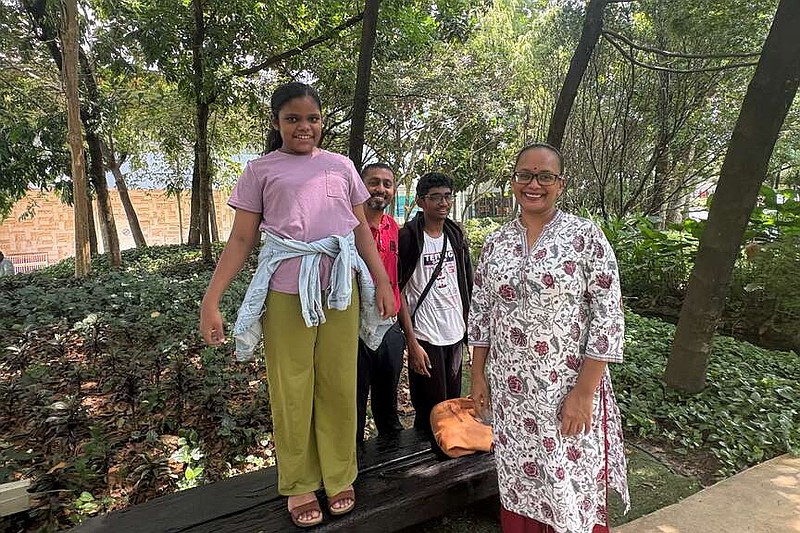 Jayaradha Veerasamy, right, and Saravanan Ganasan, second left, stand with their 12 years-old daughter Saaradha Saravanan, left, and their 15 year-old son Aadhavan Saravanan at a park in Petaling Jaya, near Kuala Lumpur, Malaysia Monday, June 1, 2026. (AP Photo/Eileen Ng)
