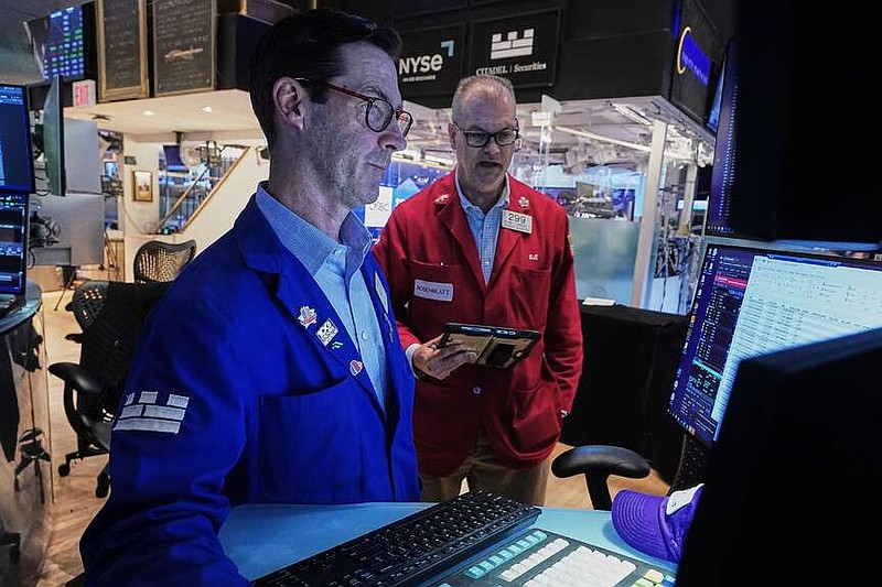 Specialist John McNierney, left, and trader William Lawrence work on the floor of the New York Stock Exchange, Wednesday, June 3, 2026. (AP Photo/Richard Drew)