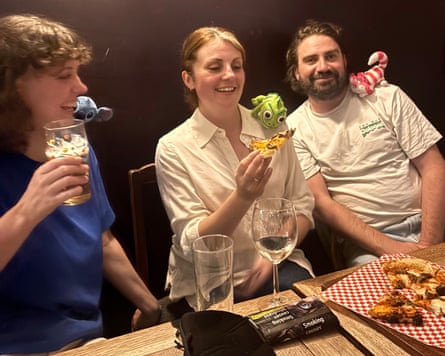 Lucy Knight and two friends in the pub wearing shoulder plushies