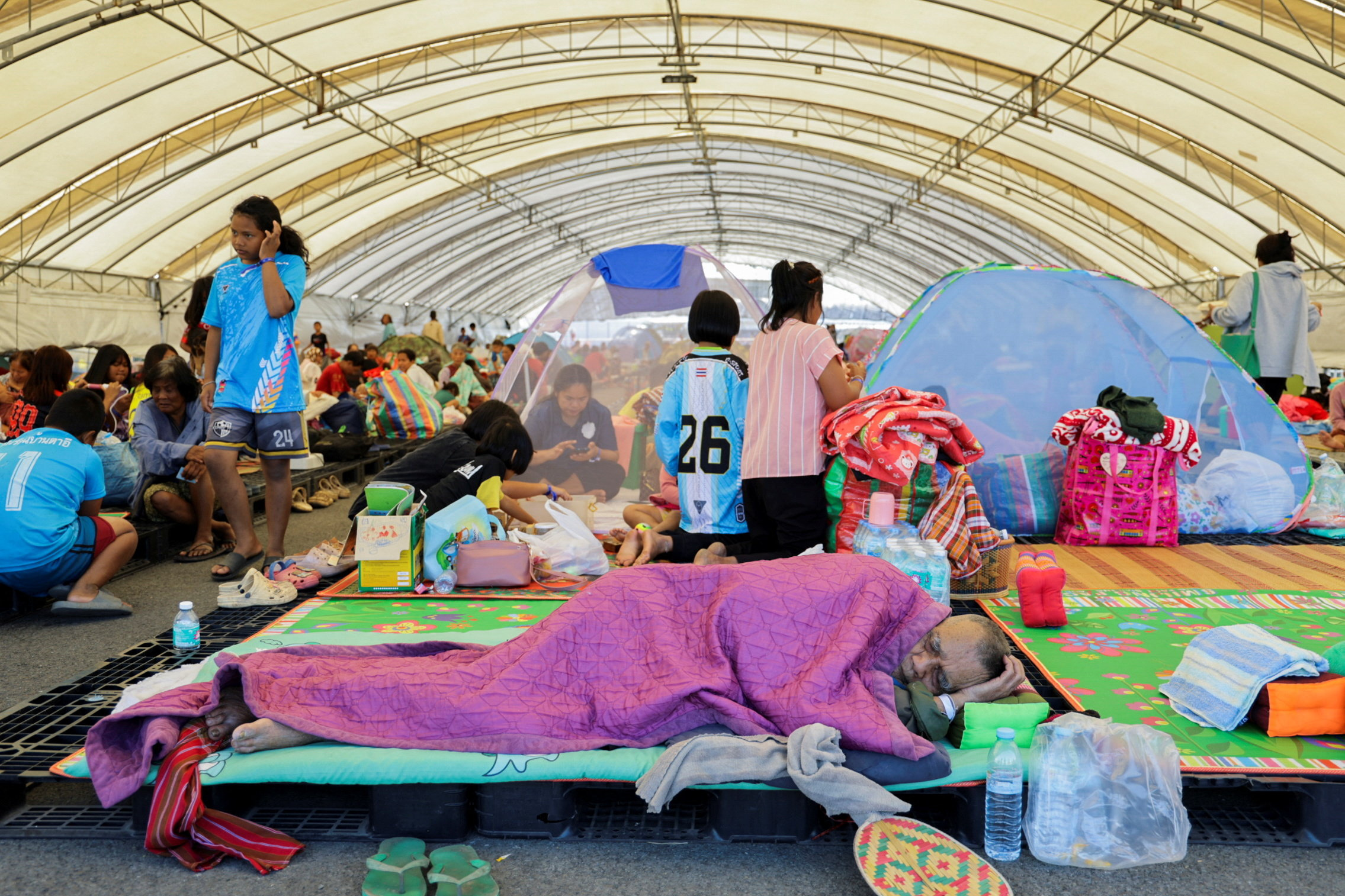 People resting at a shelter in Buriram province after military clashes between Thailand and Cambodia.