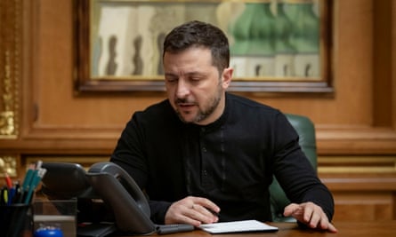 a man in black talks on the phone