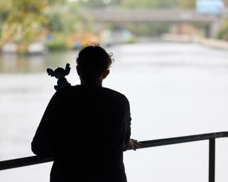 Lucy Knight and a toy Stitch in silhouette