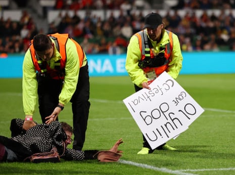 A protester is detained by stewards.