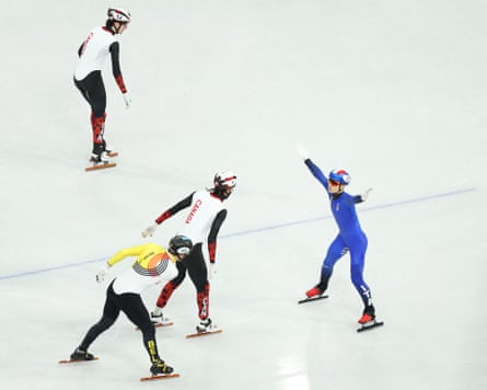 Image taken using a static remote camera shows Pietro Sighel of Italy skating backwards after crossing the finish line to win gold in the speed skating short track mixed relay at the 2026 Winter Olympics