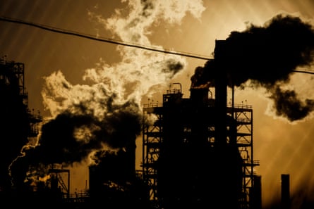 Smoke rises from a refinery.