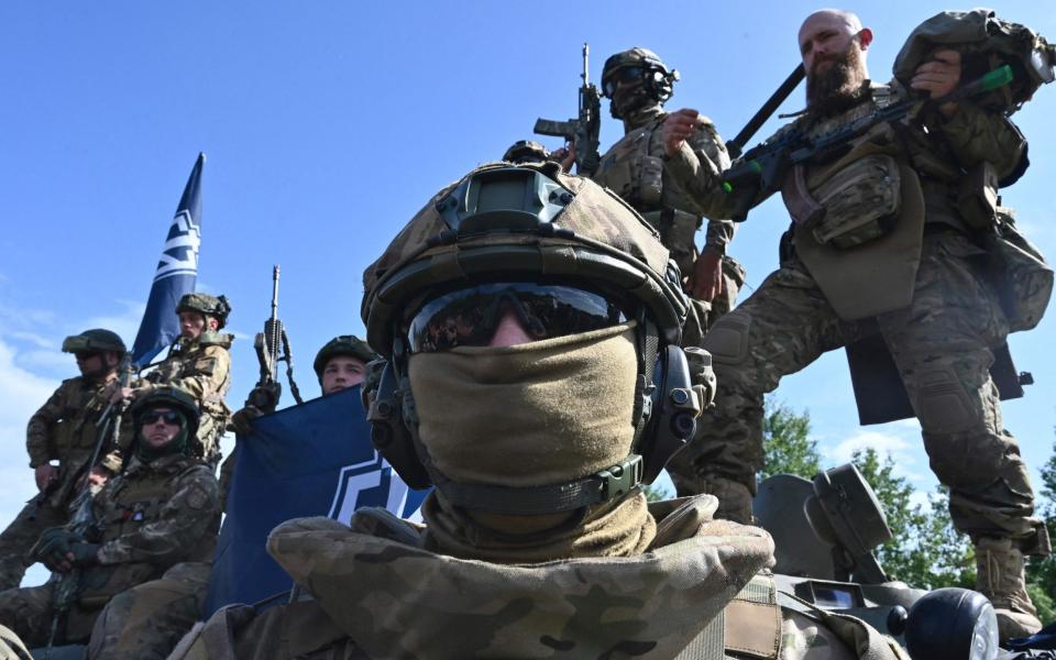 Fighters of the Russian Volunteer Corps attend a presentation for the media in northern Ukraine - AFP/SERGEY BOBOK