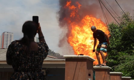 Residents leave an area surrounding the fire outside Kuala Lumpur