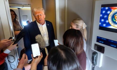 A man speaks surrounded by reporters