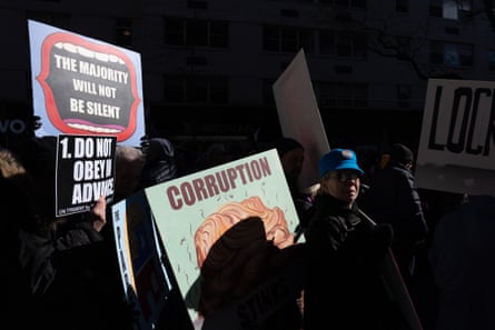 people hold signs that read ‘the majority will not be silent’ and ‘do not obey in advance’