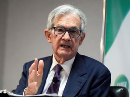 A white-haired man with glasses speaks