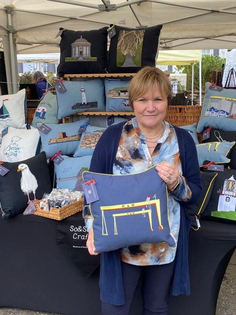Jennie showing off one of her cushions at a craft fair