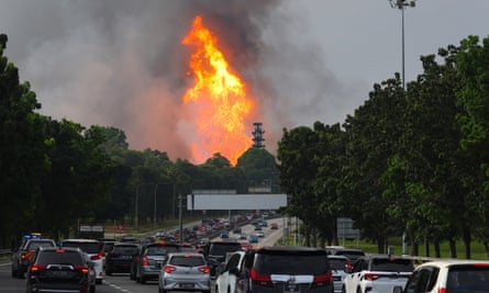Commuters pass by the gas pipeline fire in Putra Heights, Malaysia