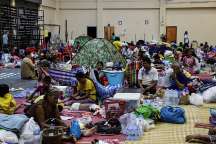 People evacuated from border areas gather at Surindra Rajabhat University evacuation centre in Thailand.