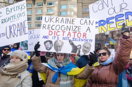 a person holds a sign that reads ‘Ukraine can recognize a dictator and it’s not Zelenskyy’