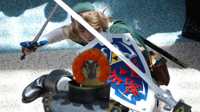 An Anime Expo 2011 photo shows The Legend of Zelda cosplayers sword fighting.