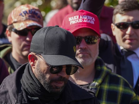 man in caps stand outside