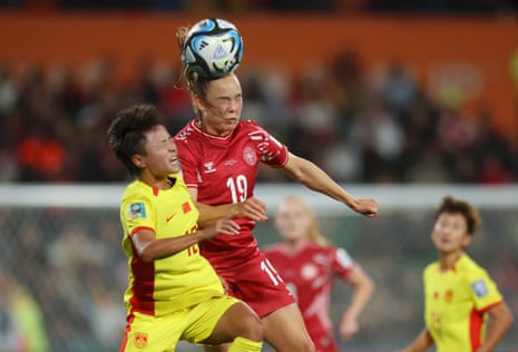Janni Thomsen of Denmark and Zhang Linyan of China compete for the ball.