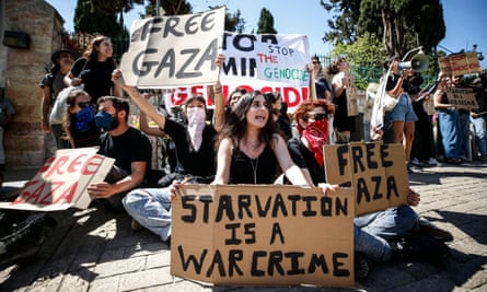 Mostly young protesters hold placards and banners with messages including ‘Free Gaza’, ‘Starvation is a war crime’ and ‘Stop the genocide’