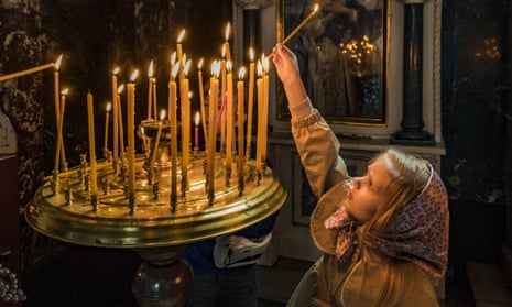 A child puts a candle in St Volodymyr's Cathedral on Orthodox Palm Sunday in Kyiv, Ukraine.